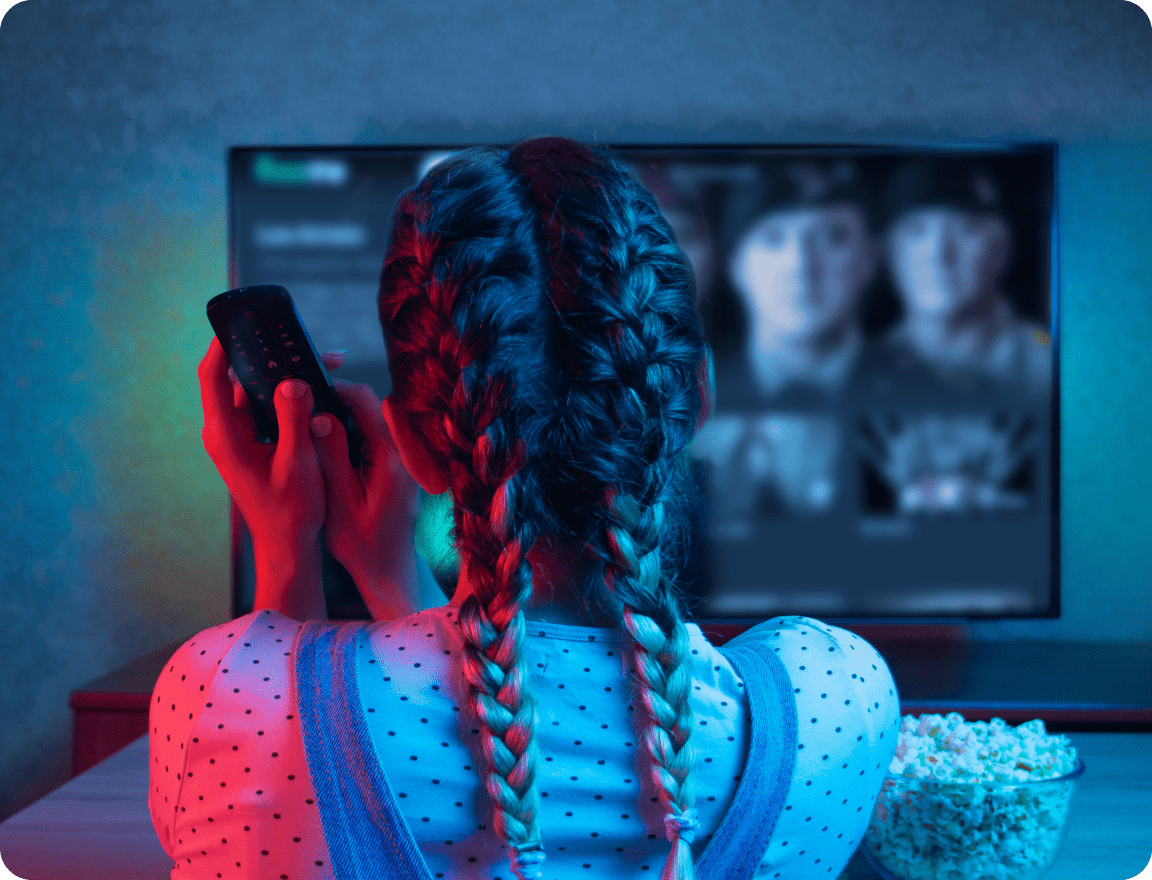 Girl with remote in front of TV